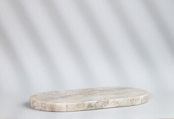 Abstract empty marble board with shadows on a gray background. Layout concept for promotional product presentation, sale or cosmetics display.