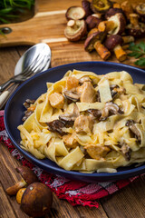 Tagliatelle pasta with forest mushrooms and chicken.