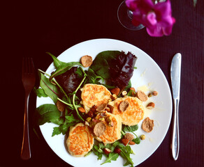 Healthly food. Healthy breakfast. Cheesecakes and salad. Food on a plate, top view. Table setting.