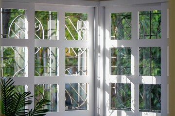 Stunning view of the outdoors  seen through a beautiful window featuring intricate glass designs