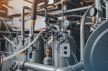 Pressure gauges and hoses on the back of industrial equipment. Connection pipes.
