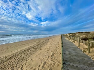 Beautiful boardwalk stretching along a sandy beach.