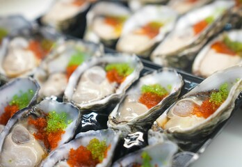 Oysters paired with orange and green fish roe