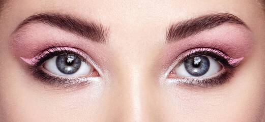 Beautiful female eyes with long eyelashes. Eyelash extensions. Makeup, cosmetics, beauty. Close up, macro