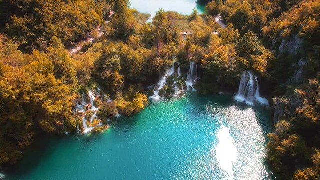 Scenic autumn landscape of waterfall in colourful forest. Aerial view of Plitvice Lakes National Park. Famous travel destination in Croatia.