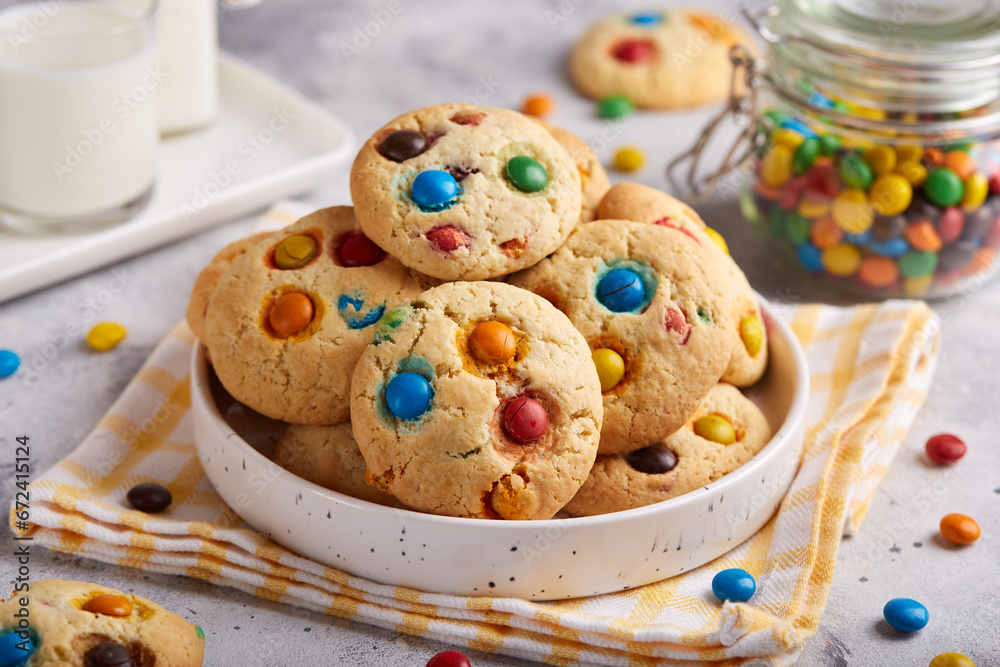 Canvas Prints American cookies with colorful chocolate candy drops served with glass of milk. Delicious homemade dessert for children.