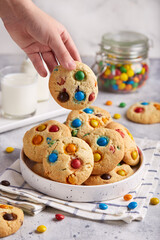 American cookies with colorful chocolate candy drops served with glass of milk. Delicious homemade...