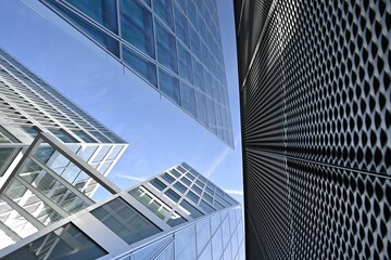 Low angle of high-rise modern architecture buildings with metallic facades and windows
