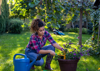 Girl taking care of plants in garden