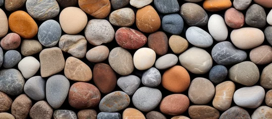 Fotobehang Stenen in het zand A background texture composed of small circular stones