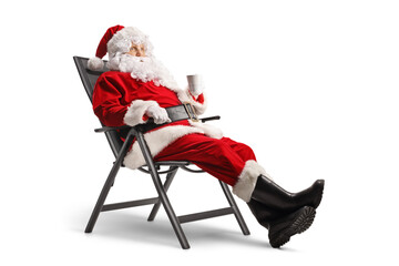 Santa claus sitting on a chair with a cup of tea