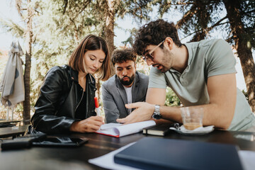 Business professionals strategizing outdoors at a downtown coffee bar, discussing budget management, innovation, and sales strategy for successful business growth.