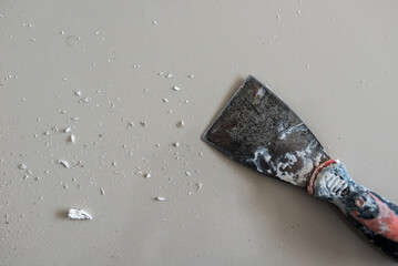 Cans of paint and trowel on a white background.
