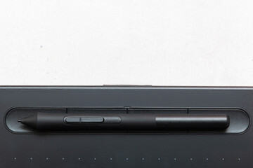 Top view of graphic tablet and pen for illustrators, designers and photographers on light 
background. 3d rendering