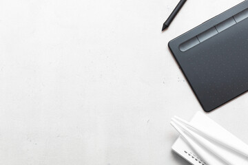Top view of graphic tablet and pen for illustrators, designers and photographers on light...
