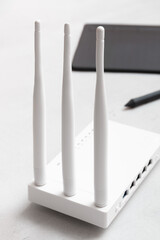 The router for Wi-Fi distribution is on a light table.