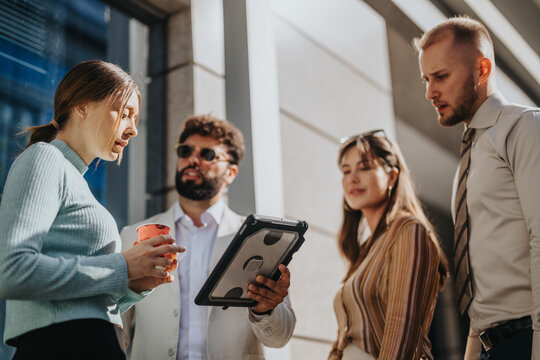 A Multicultural Corporate Team Collaborates Outdoors, Discussing Market Trends, Strategizing For Global Expansion, And Focusing On Product Innovation, Profitability, And Customer Relations.