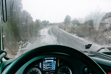Interior of the cab of a truck with the windshield fogged by condensation due to the change in...