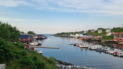 Fototapeta na wymiar Sorvagen harbor in Norway, with a bustling fleet of boats and yachts in the deep blue waters