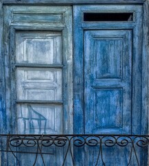 Close-up shot of a vintage, blue wooden door