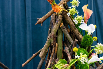 Fototapeta premium Decorative decoration made of dry sticks and flowers.