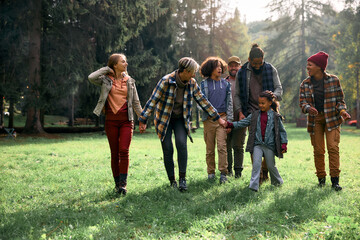 Two happy families enjoying in walk during their camping trip in nature.