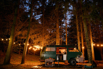 Travel van on campsite at night.