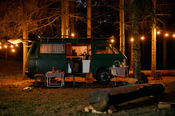 Fototapeta na wymiar Camper van at night in woods.
