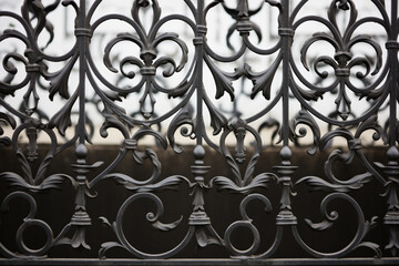 Fototapeta na wymiar Intricate wrought iron fence texture with ornate designs