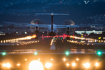 Large commercial airplane landing or take off on runway at night. Journey abroad tourism, oversea...