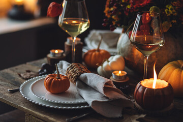 Elegant seasonal fall table setting with floral composition in a pumpkin vase as a centrepiece....