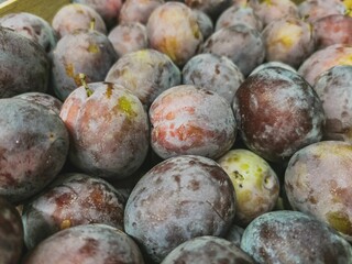 A close-up of Santa Clara plums in wooden crates. Prepared for sale on a pallet