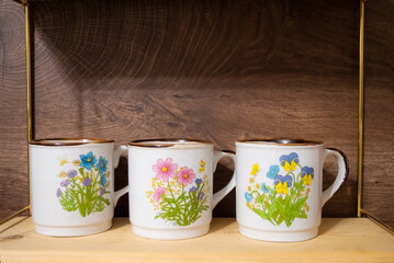 Vintage cups with flower decorations for coffee or tea