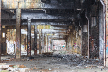 Fototapeta na wymiar Messy abandoned factory warehouse. Creepy industrial hall