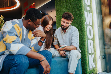 Diverse team of professionals collaborating in a co-working space, solving problems and working on new projects. Their persistent teamwork in this small company's workspace drives growth and success.