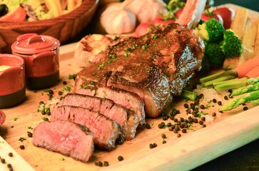 Succulent steak and roasted vegetable medley served on a rustic wooden board