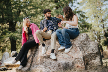 Caucasian friends gather in a city park, enjoying a carefree conversation. Surrounded by nature,...