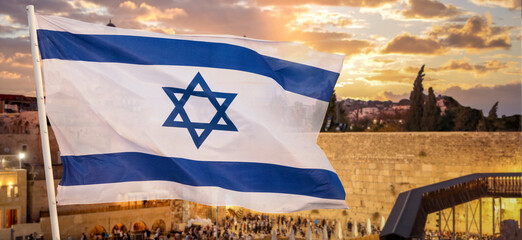 Flag of Israel in the wind against the background the Wailing Wall blurred with the yellow sky November 2, 2023 Jerusalem  Israel
