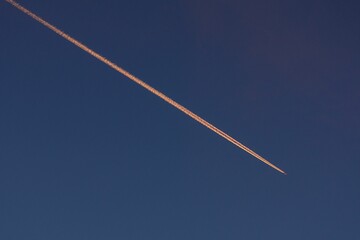Thin white streak is visible in the sky, a remnant of an aircraft's passage.