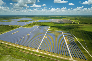 Aerial view of big sustainable electric power plant with many rows of solar photovoltaic panels for producing clean electrical energy. Renewable electricity with zero emission concept