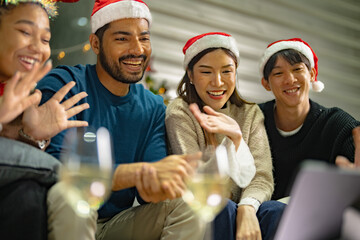 close up face of asian young teen calling through screen tablet to friends. party of people celebrating by technology online communication. friend female and male celebrating christmas at home.