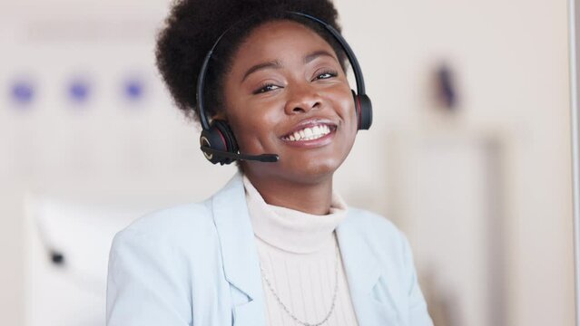 Portrait of a friendly call center agent using a headset while consulting for customer service and sales support. Young business woman with a big smile working on a computer and operating a helpdesk