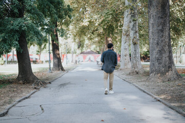Male person hanging out in the city park alone.