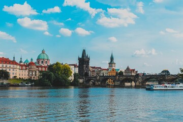 Scenic outdoor scene of a sparkling river with Charles bridge in the background in Prague