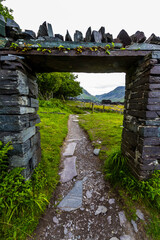 Slate  gate framing Path in welsh slate quarry, Snowdonia or Eryri National Park. - 672457119