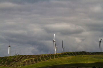 Wind Turbines, with cloudy sky as copyspace. - 672457152