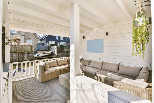 Elegant cozy couch with white wall in porch