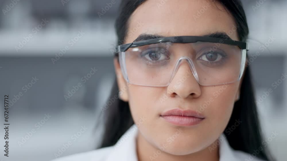 Poster Phd scientist wearing goggles for safety in a research lab. Portrait of a microbiologist looking serious and confident in finding a cure for covid. Ready for chemical science experiments and tests