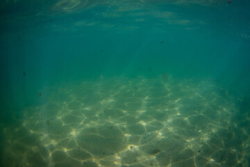 Beautiful wavy pattern on the sand underwater.