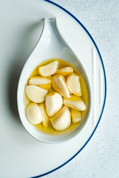 Baked organic garlic in oil on spoon